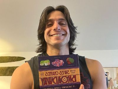 Gideon Glick is holding the book as he can be seen smiling.